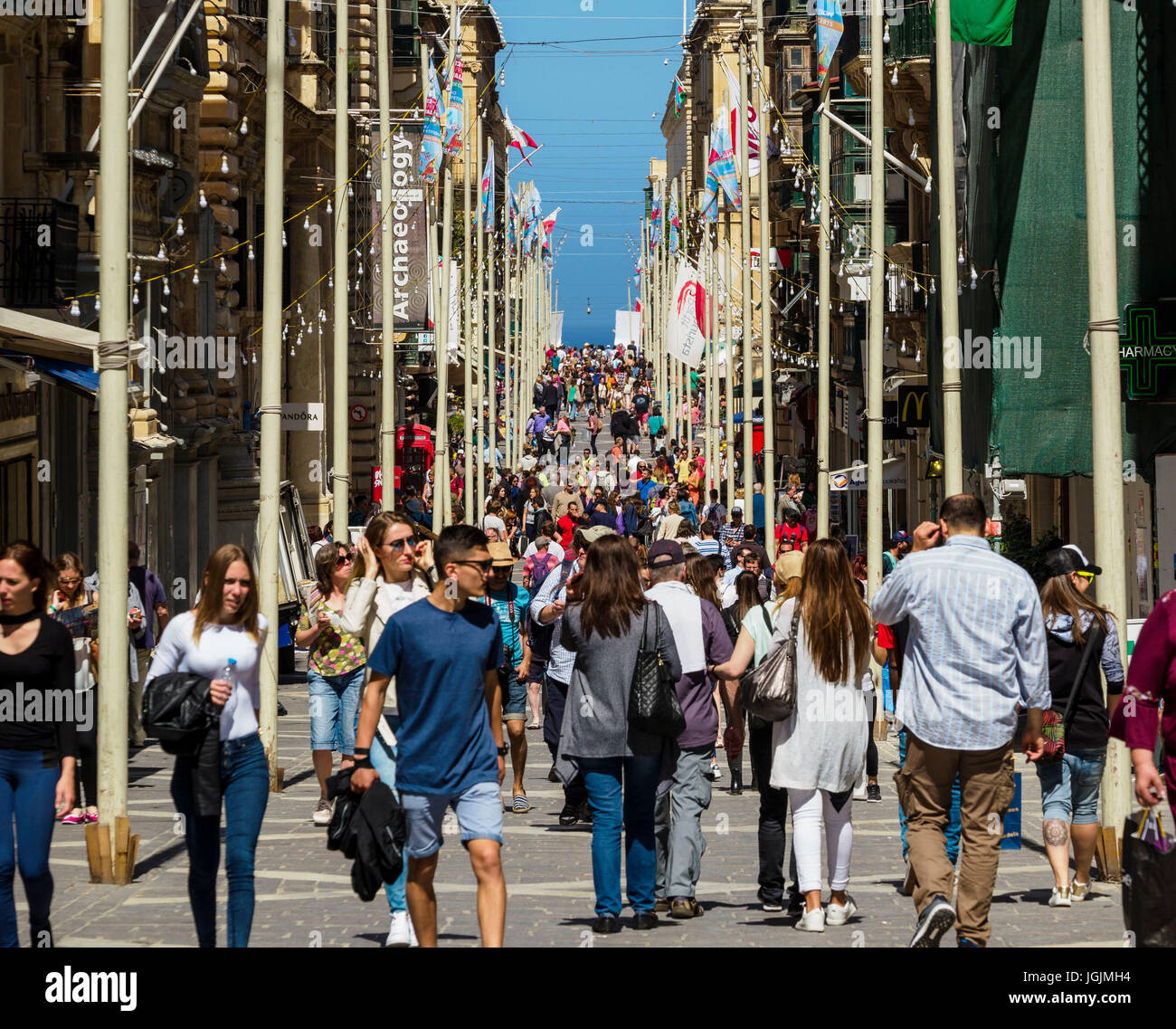 Pedestrians walk over Republic Street / Triq Ir-Repubblika at Valletta  / Malta. Stock Photo