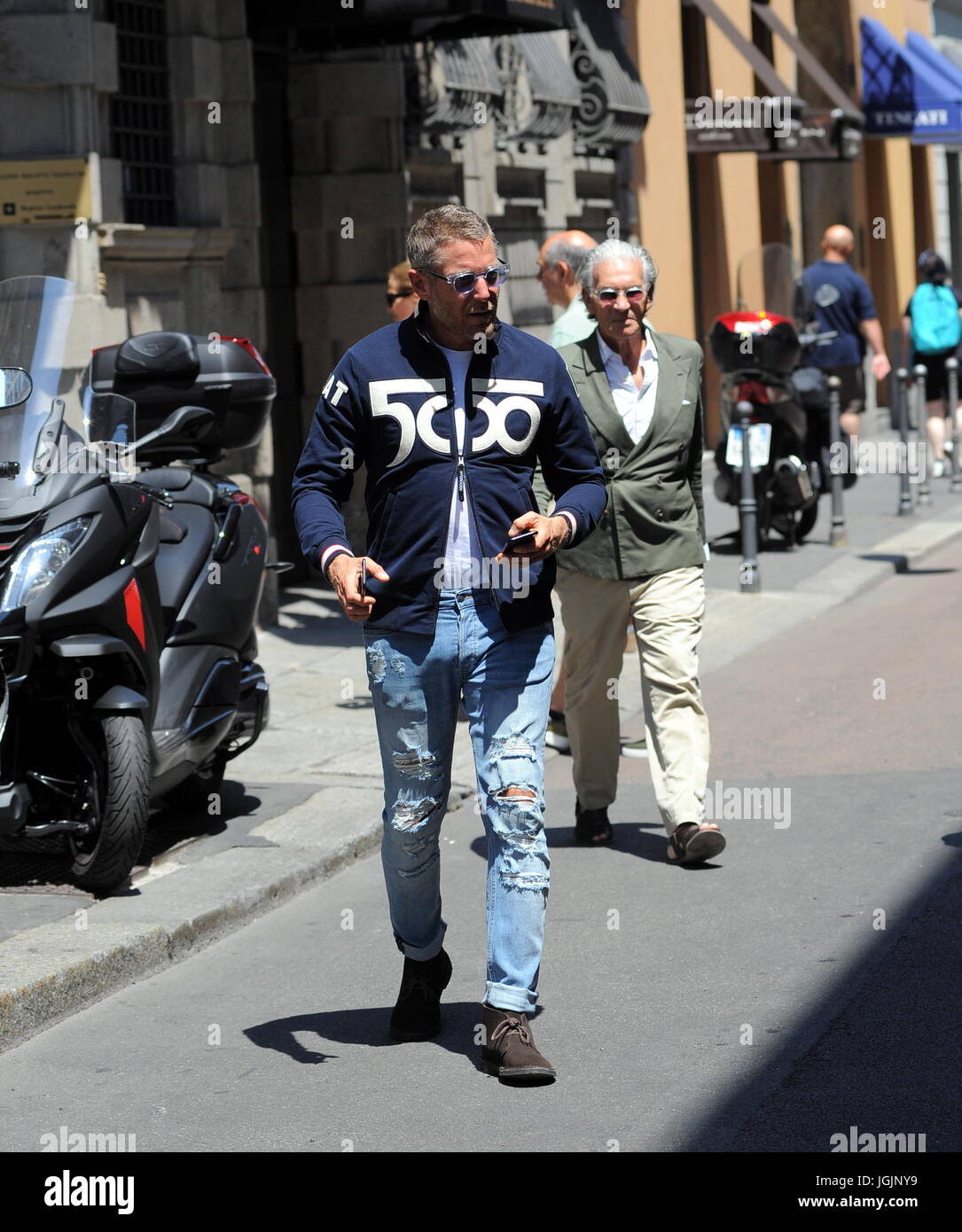 Milan, Lapo Elkann goes to lunch in downtown with Fiat500 anniversary sweater Lapo Elkann arrives in the center dressed casually, sporadically, and wearing tattered trousers and a Fiat500 sweater, to celebrate the 60th anniversary of the legendary car, park the His car at the 'Four Seasons Hotel' goes to a working lunch. After eating at the 'Salumaio di Montenapoleone' greets her customer friend, she handles her Fiat 500 and returns to the office. Stock Photo