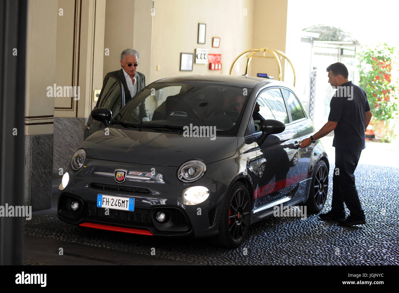 Milan, Lapo Elkann goes to lunch in downtown with Fiat500 anniversary sweater Lapo Elkann arrives in the center dressed casually, sporadically, and wearing tattered trousers and a Fiat500 sweater, to celebrate the 60th anniversary of the legendary car, park the His car at the 'Four Seasons Hotel' goes to a working lunch. After eating at the 'Salumaio di Montenapoleone' greets her customer friend, she handles her Fiat 500 and returns to the office. Stock Photo