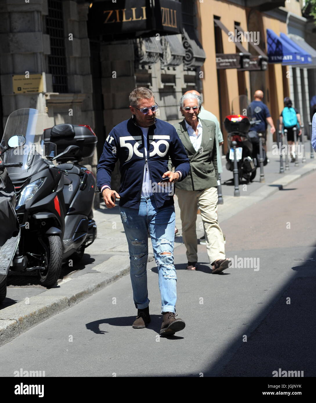 Milan, Lapo Elkann goes to lunch in downtown with Fiat500 anniversary sweater Lapo Elkann arrives in the center dressed casually, sporadically, and wearing tattered trousers and a Fiat500 sweater, to celebrate the 60th anniversary of the legendary car, park the His car at the 'Four Seasons Hotel' goes to a working lunch. After eating at the 'Salumaio di Montenapoleone' greets her customer friend, she handles her Fiat 500 and returns to the office. Stock Photo