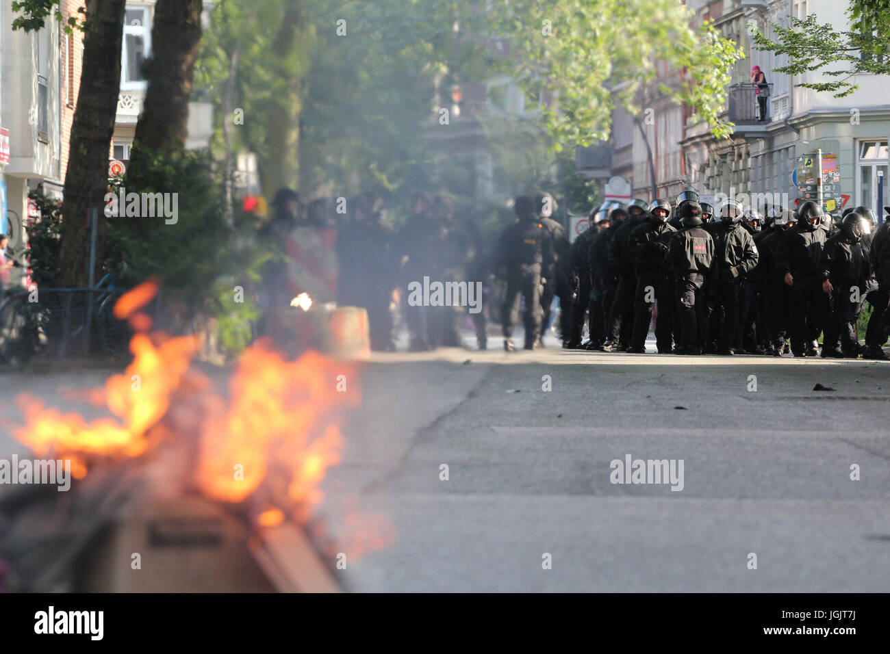 Hamburg, Germany. 07th July, 2017. G20 Summit protests in Hamburg. Police look on as barricade is set alight. Credit: Conall Kearney/Alamy Live News Stock Photo