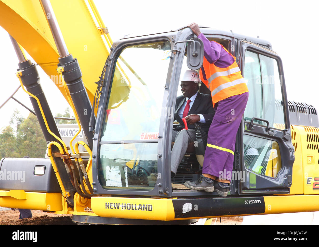 (170707) -- ELDORET(KENYA), July 7, 2017 (Xinhua) -- Kenyan Deputy President William Ruto (L) drives an excavator to break ground at the launching ceremony of the Special Economic Zone project in Eldoret, Kenya, on July 7, 2017. Kenya on Friday launched a Special Economic Zone (SEZ) project that is expected to attract about 2 billion U.S. dollars of foreign investments. The project is a joint venture between Kenyan-based company Africa Economic Zone and China's Guangdong New South Group. (Xinhua/Pan Siwei) Stock Photo