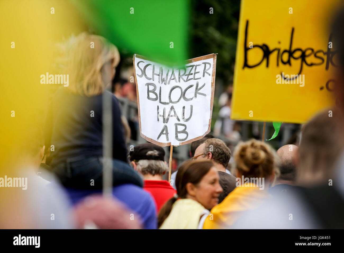 Hamburg, Germany. 8th July, 2017. A protestor holds a placard with the slogan 'get lost black bloc' at the 'Borderless Solidarity rather than G20' demonstration in Hamburg, Germany, 8 July 2017. The two-day summit, a meeting of the leaders of the twenty largest world economies as well as representatives of a variety of international institutions, has been met with a wave of protests. Photo: Sina Schuldt/dpa/Alamy Live News Stock Photo
