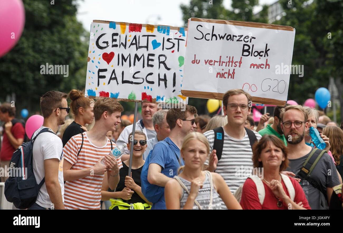 Hamburg, Germany. 8th July, 2017. Protestors at the 'Hamburg Shows Attitude' demonstration wave placards with the slogans 'violence is always wrong!' (L) and 'Black bloc, you don't represent me - no G20' in Hamburg, Germany, 8 July 2017. The two-day summit, a meeting of the leaders of the twenty largest world economies as well as representatives of a variety of international institutions, has been met with a wave of protests. Photo: Sina Schuldt/dpa/Alamy Live News Stock Photo