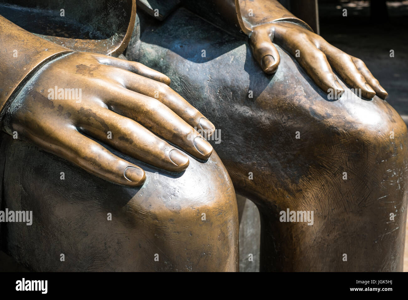 hands on knees sculpture - bronze statue, Stock Photo