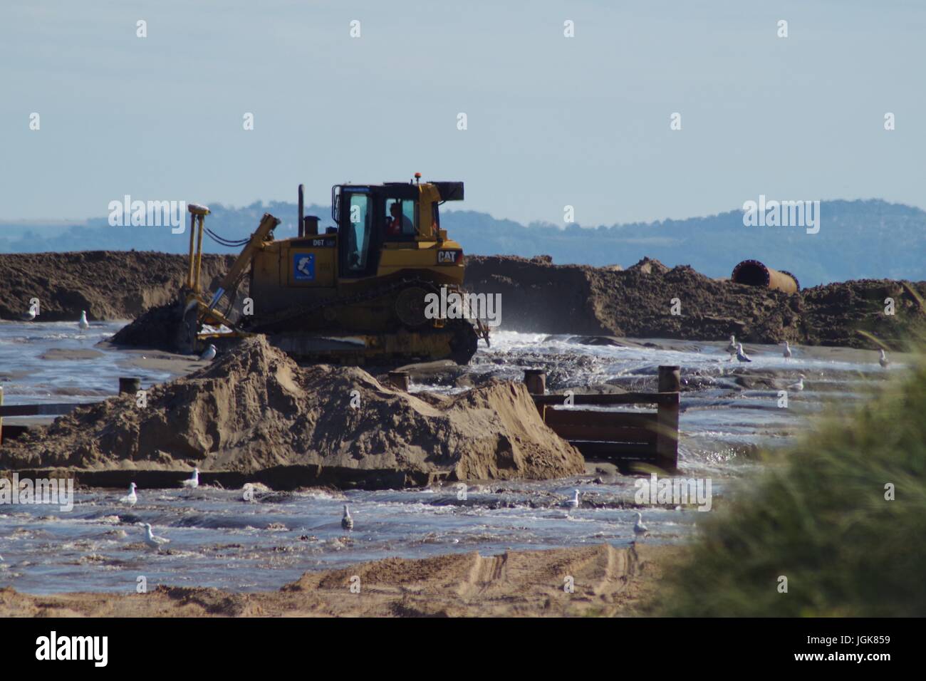 Excavators Shaping Dredged Sand to Replenishing the Beach at Dawlish Warren. Devon, UK. July, 2017. Stock Photo