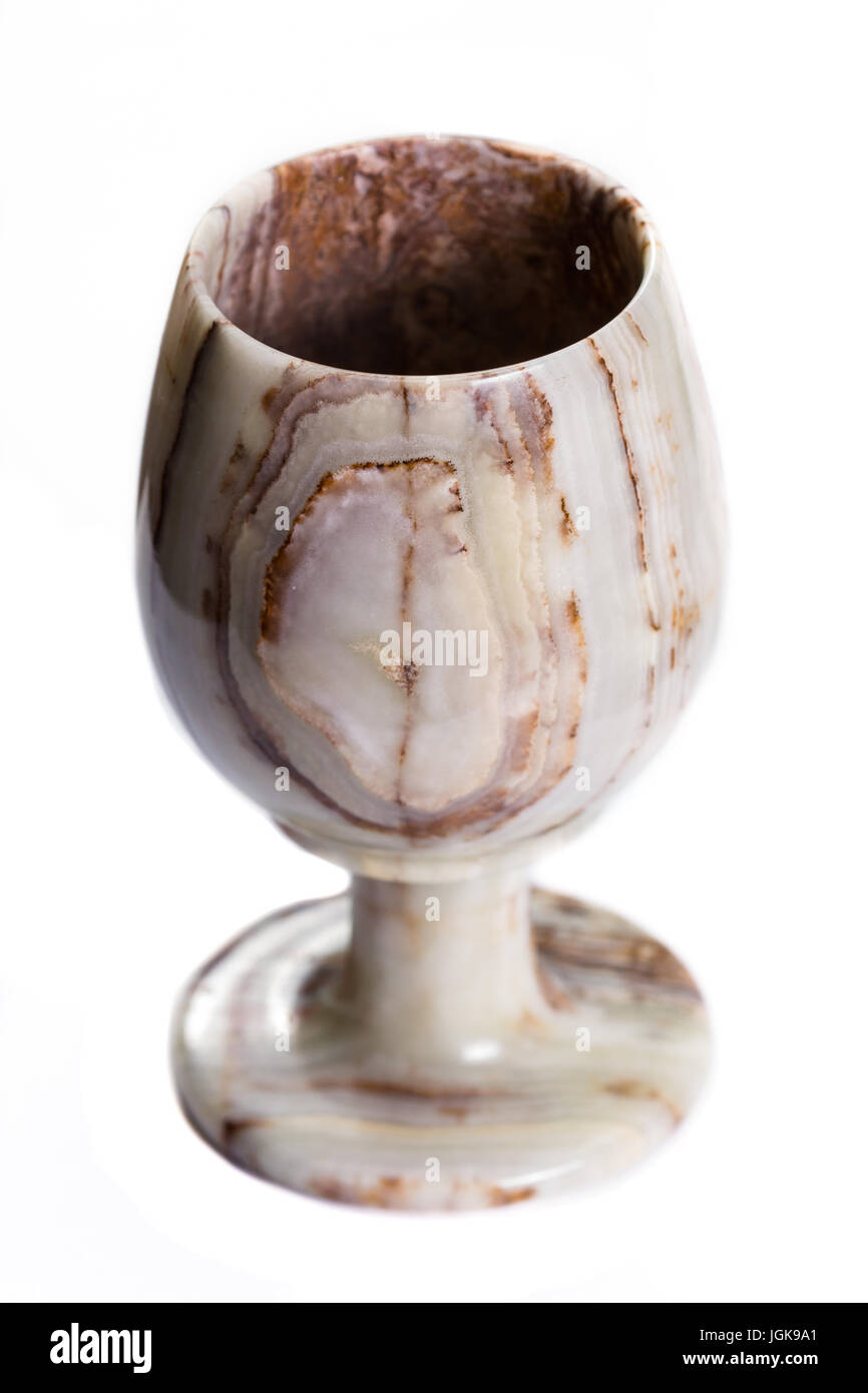 close up of a beautiful onyx cup with unique swirls and layers isolated on a white background Stock Photo