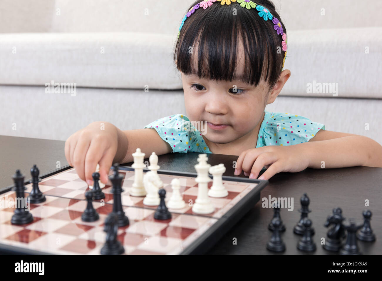 Children's Restraining Hand Thoughtfully Figure Before The Next Chess Move  Stock Photo, Picture and Royalty Free Image. Image 77247675.