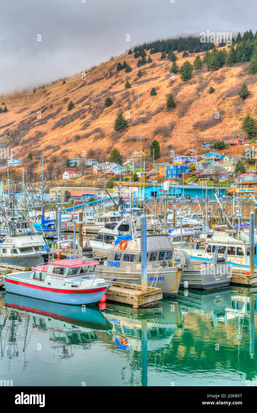 Colorful fishing boats with reflections in the marina at Kodiak, Alaska