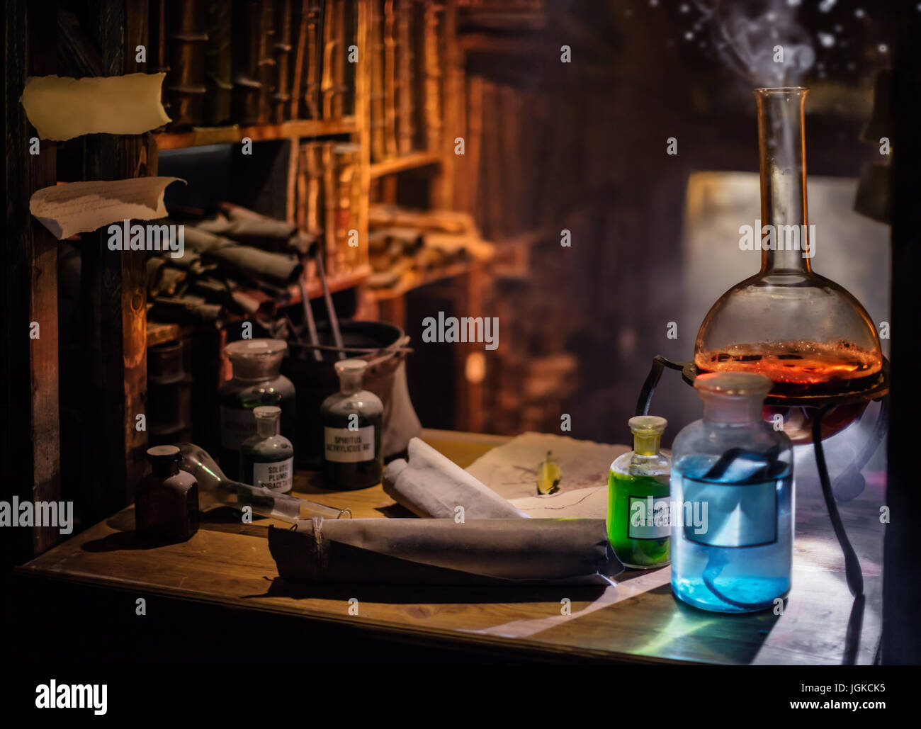 Medieval alchemist laboratory with various kind of flasks and old books