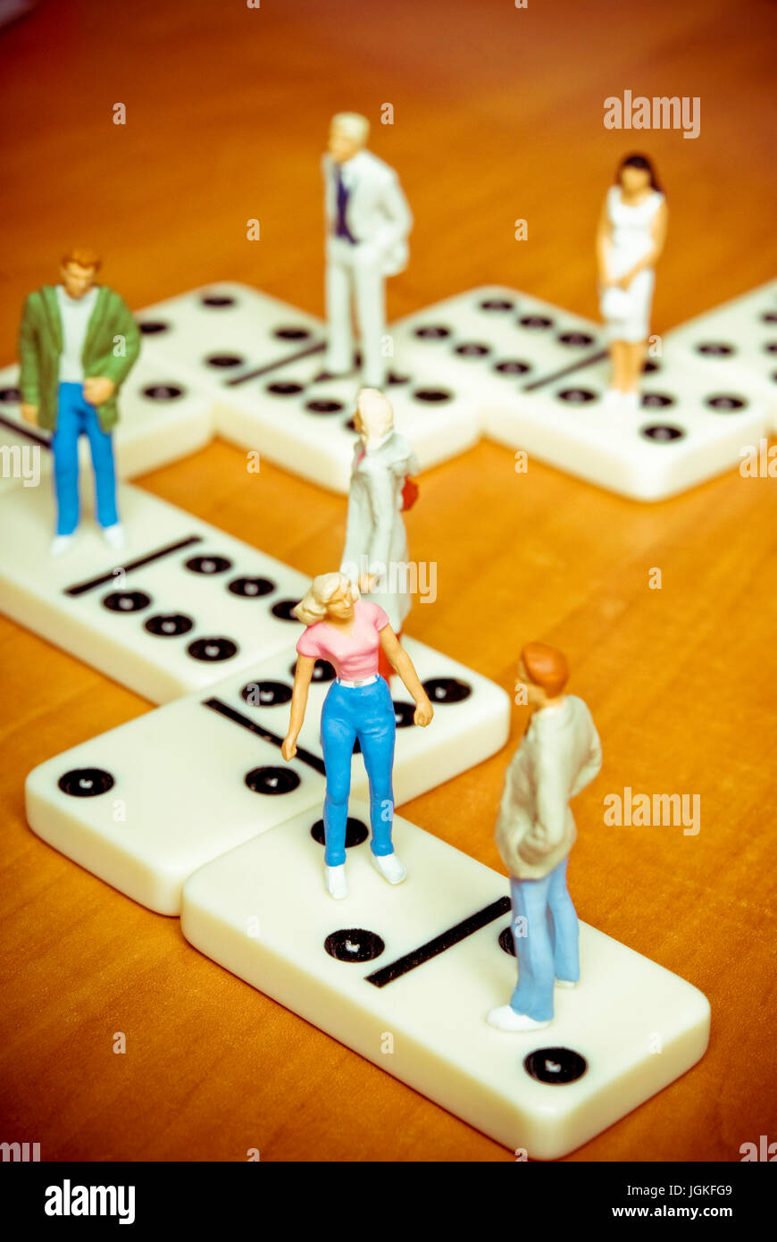 men and women figurines standing on dominoes tiles connected, social media and social relationship and social itneractions concept Stock Photo