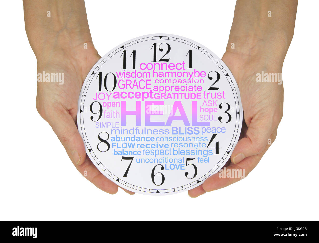 There is always time for Healing - female hands holding a clock face containing a pink and blue graduated HEAL word cloud  isolated on a white  backgr Stock Photo