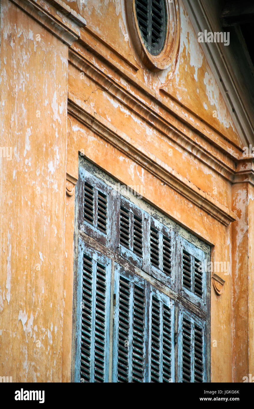 Shuttered window, old French colonial building, Setthatirath Road, Vientiane, Laos Stock Photo