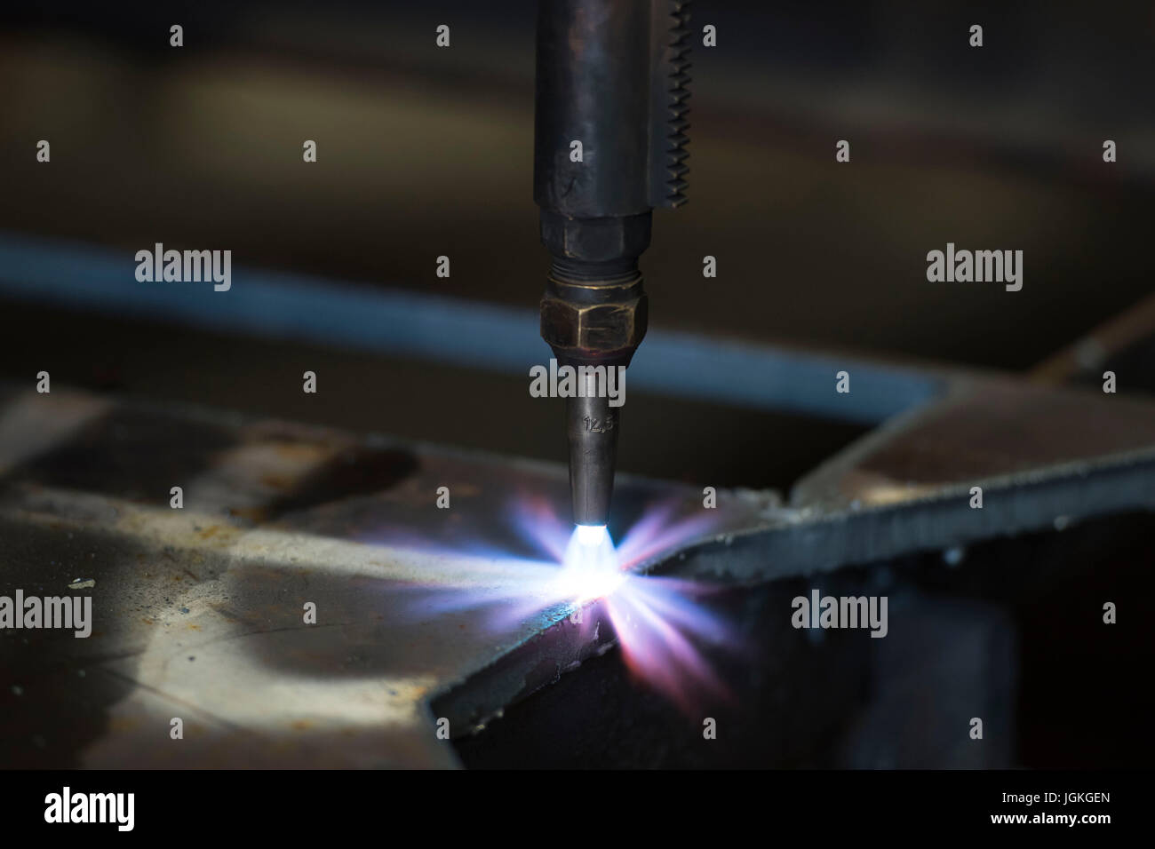 A steel cutting machine at work in a factory Stock Photo