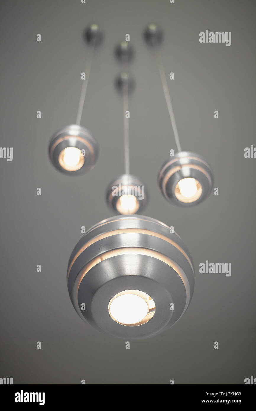 Details of a modern decorative lights, metal balls hanged on high gray