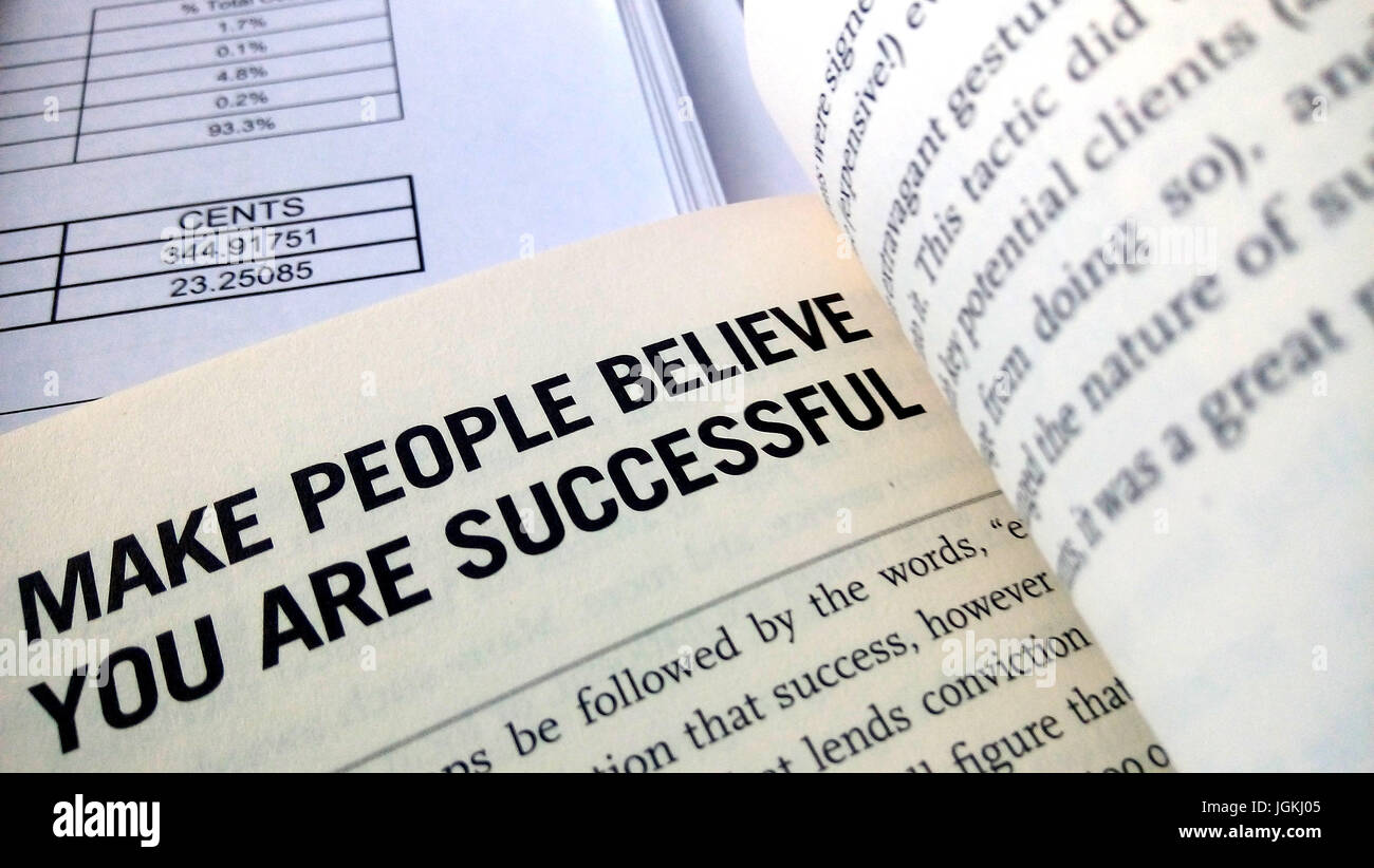 Make people believe you are successful word on the book with balance sheet as background Stock