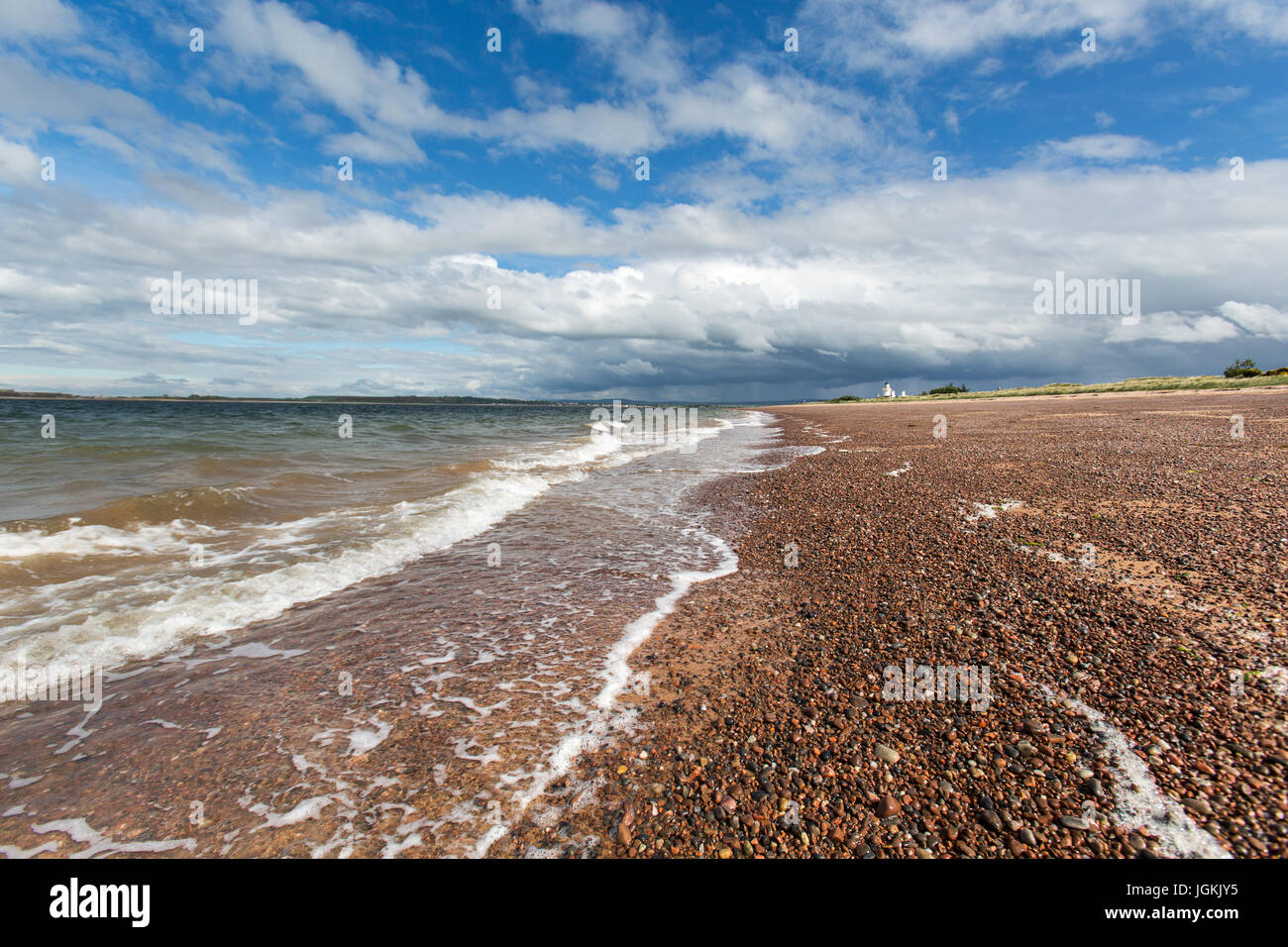 Town of Fortrose, Scotland. Picturesque view of the Rosemarkie Bay beach with Chanonry Point Lighthouse in the background. Stock Photo