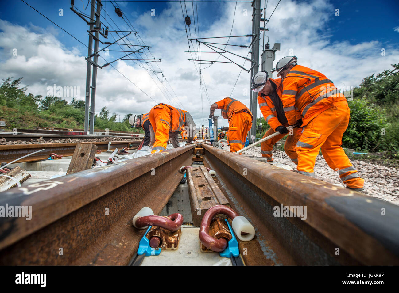 Railway construction workers laying new track Stock Photo Alamy