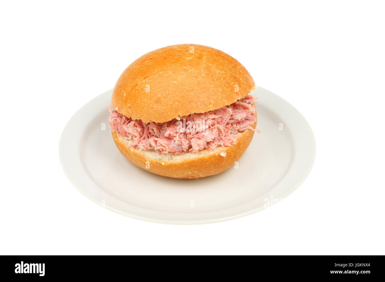 Pulled pork in a crusty bread roll on a plate isolated against white Stock Photo