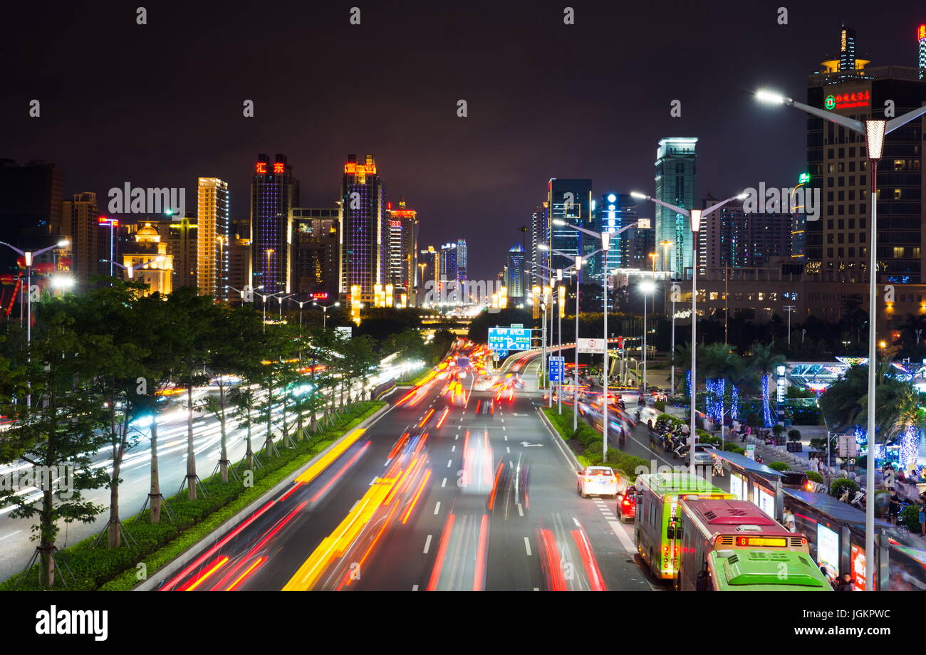NANNING, CHINA - JUNE 9, 2017: Qingxiu District busy traffic with light trails and high illuminated  buildings. Nanning is the capital city of Guangxi Stock Photo