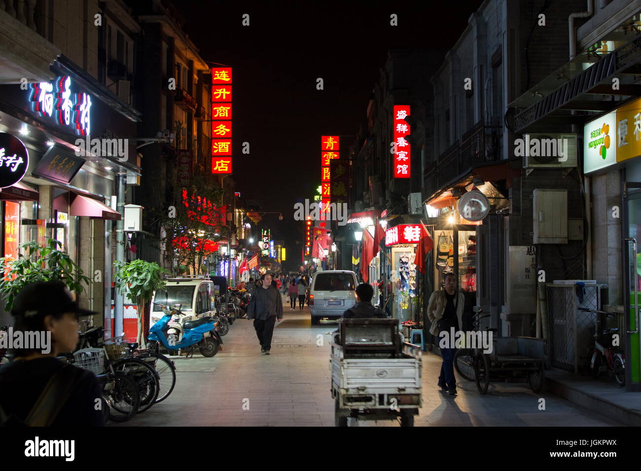 BEIJING, CHINA - SEPTEMBER 29: Hutong street night view with people walking. Beijing city center area Stock Photo