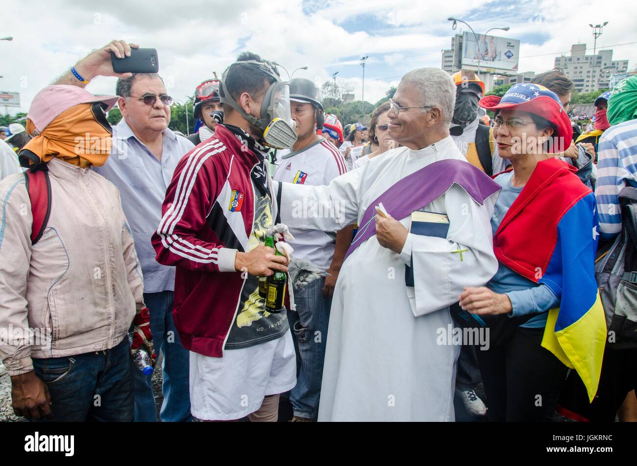 A priest blesses demonstrators on the freeway. Opposition protesters assembled on the Francisco Fajardo motorway, near Francisco de Miranda Air Force  Stock Photo