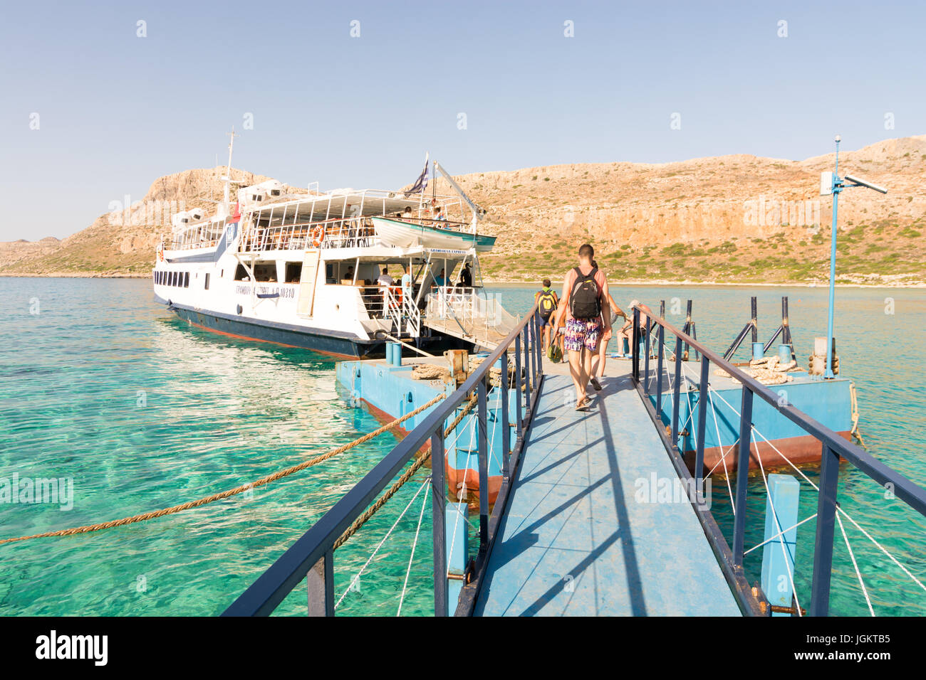 Walking the jetty to board the boat,  Balos Beach and Lagoon, north-west Crete, Greece, on the western side of the Gramvoussa peninsula. Stock Photo