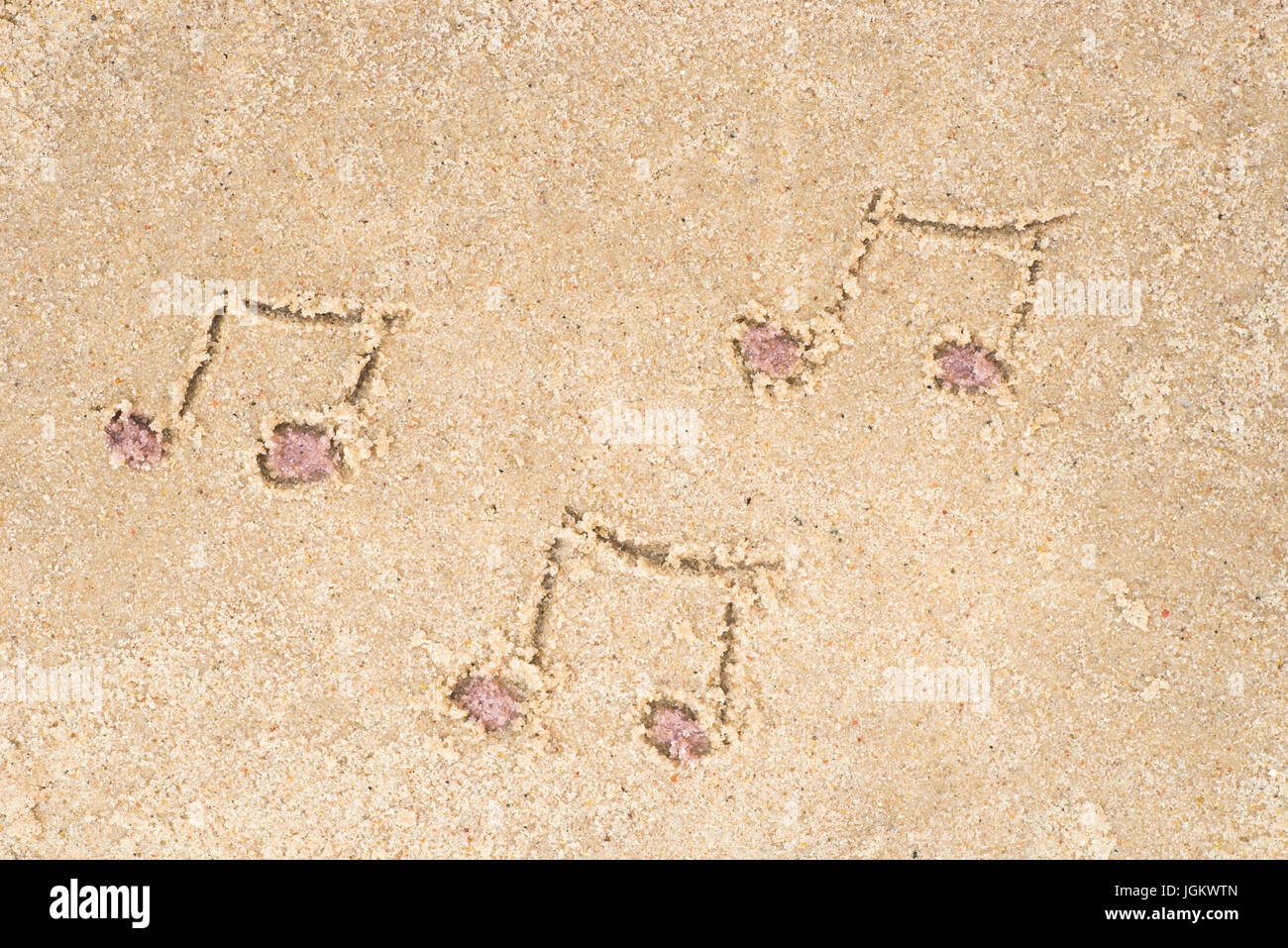 music notes drawing in sand background Stock Photo