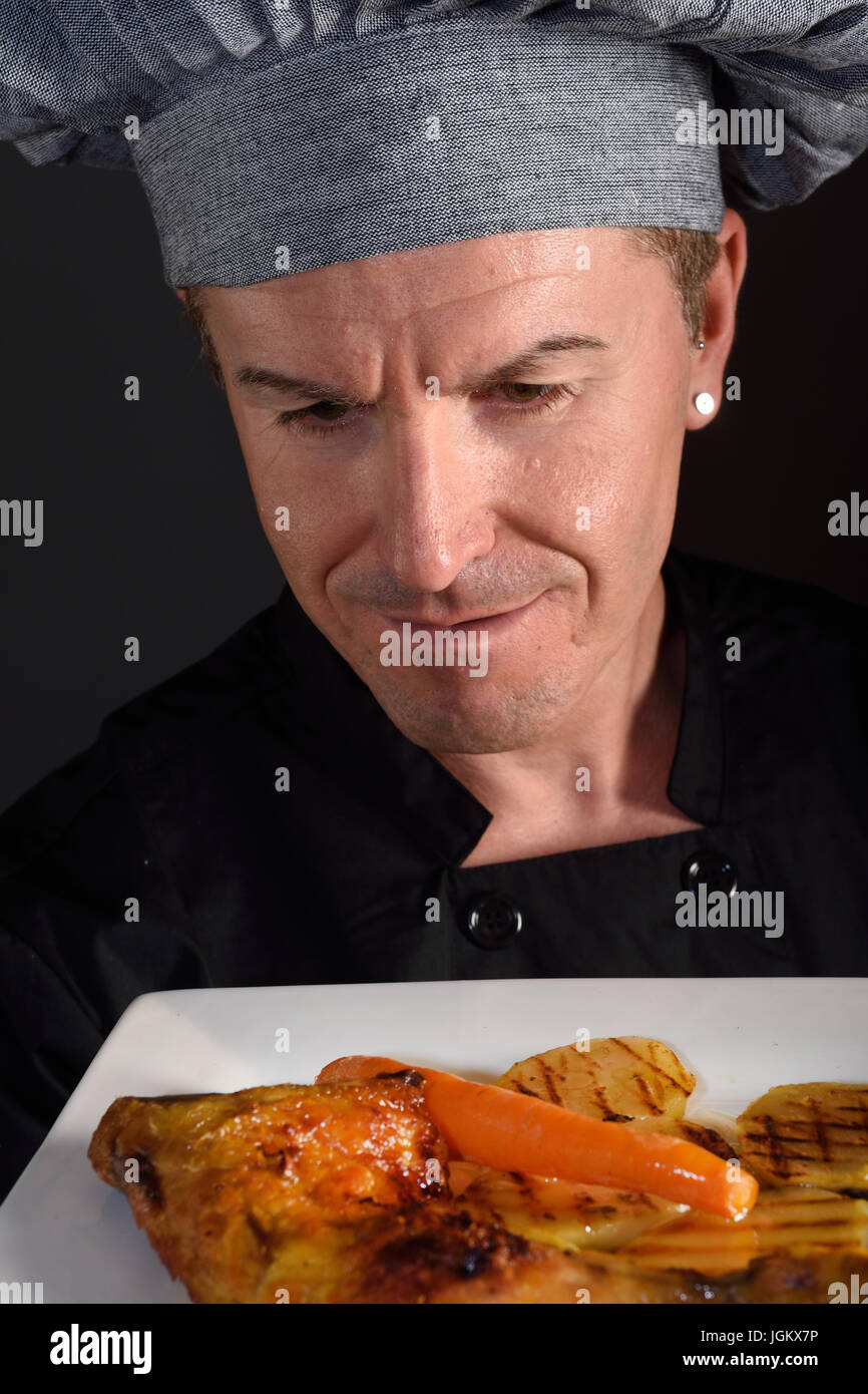 chef preparing a chicken dish with garnish Stock Photo Alamy