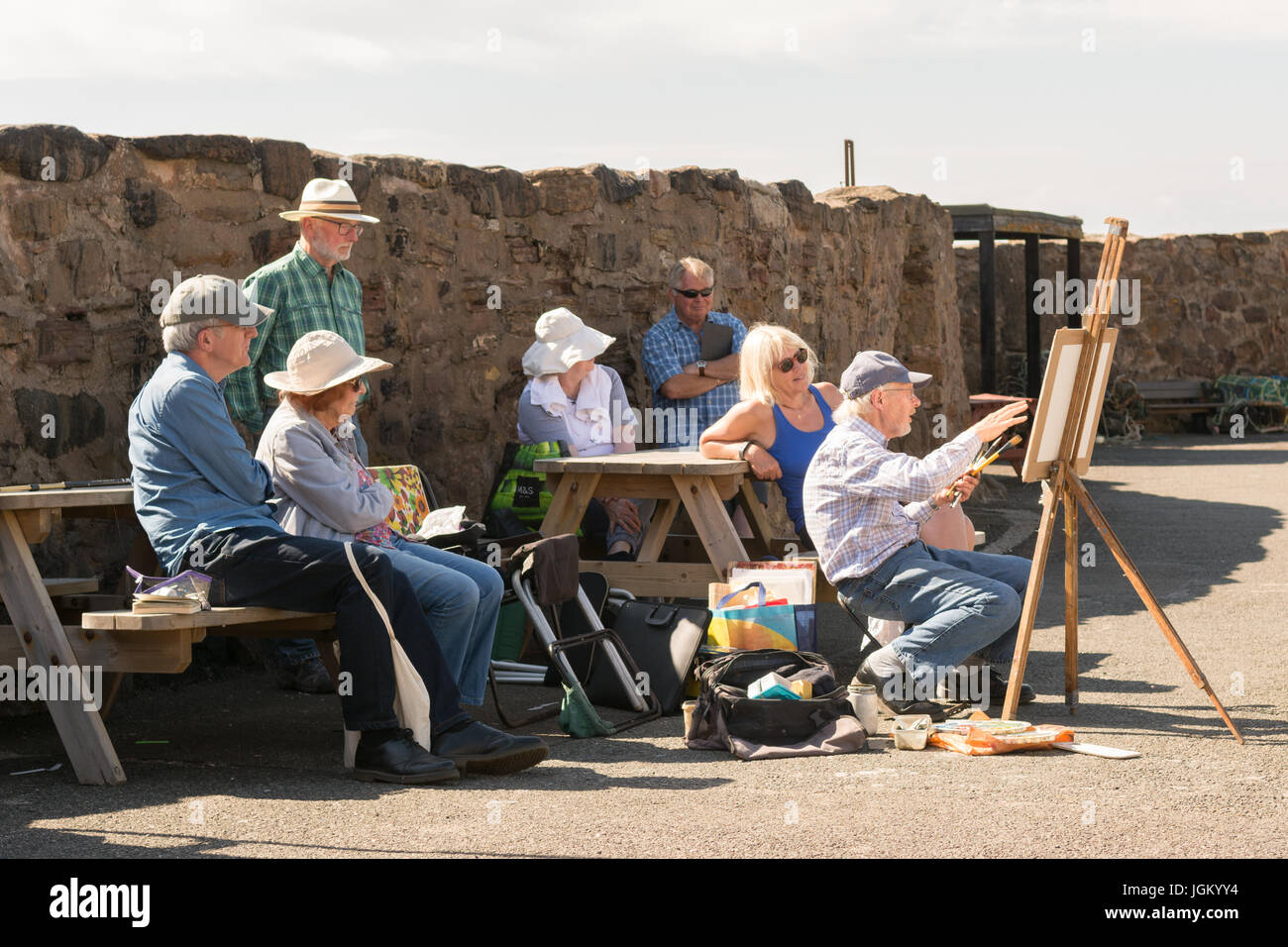 group of artists watching painting demonstration on Crail harbour, Crail, Scotland UK Stock Photo