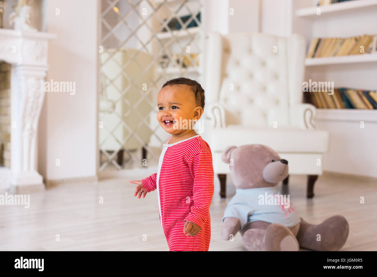 Happy baby boy playing with his teddy bear Stock Photo - Alamy