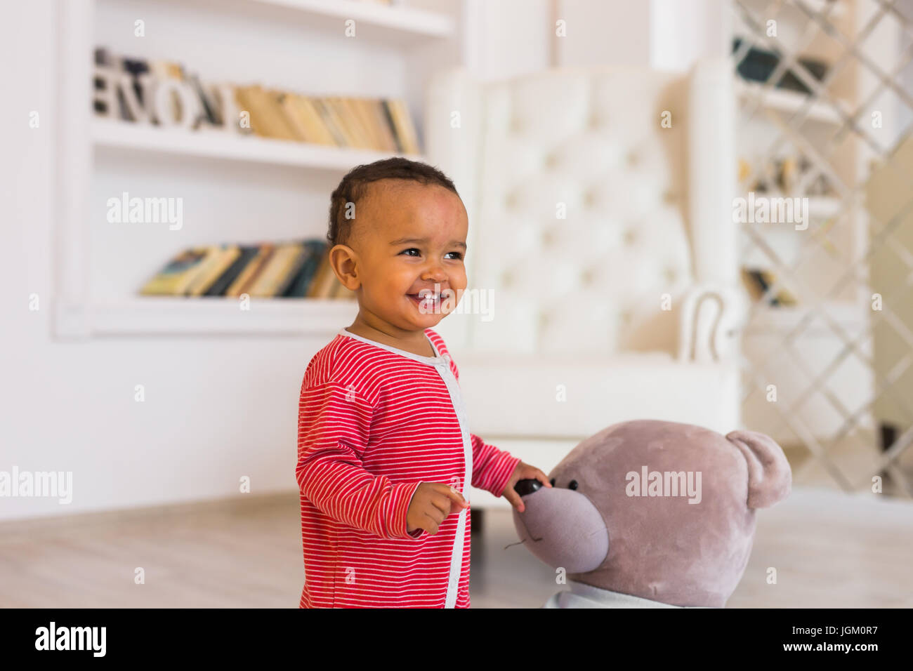 Happy baby boy playing with his teddy bear Stock Photo - Alamy