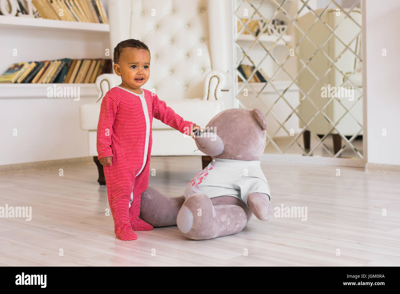Happy baby boy playing with his teddy bear Stock Photo - Alamy