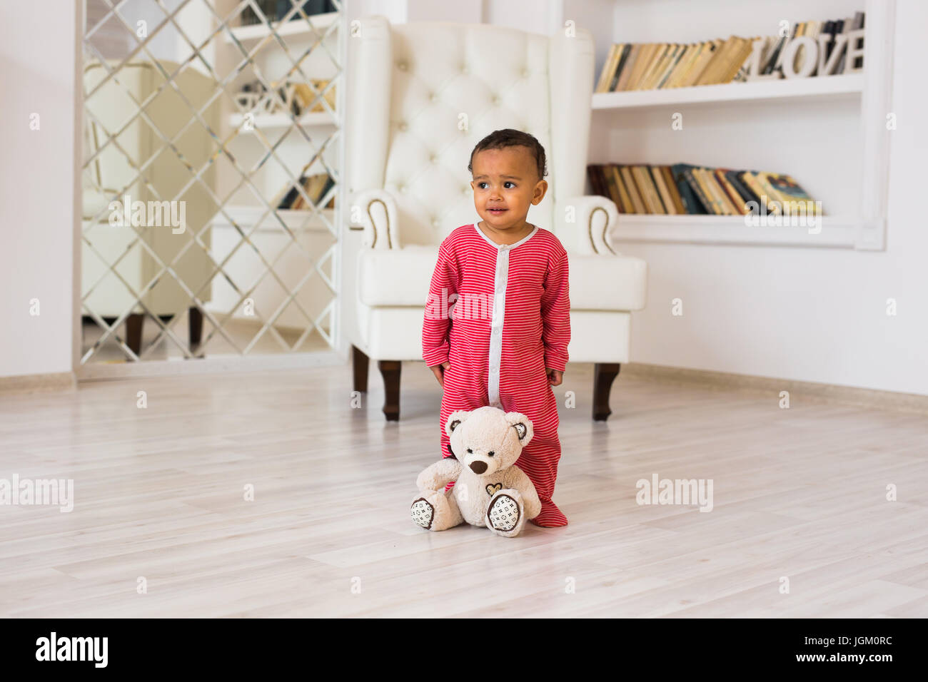 Happy baby boy playing with his teddy bear Stock Photo - Alamy