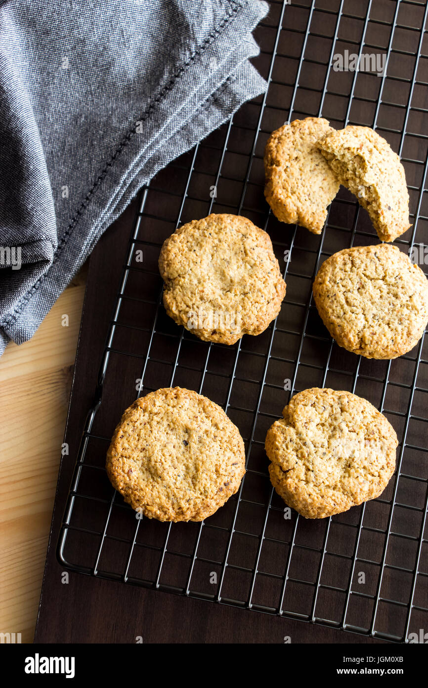 Gluten free homemade oatmeal cookies and napkin on cooling rack. Vertical. Selective focus. Toned photo Stock Photo