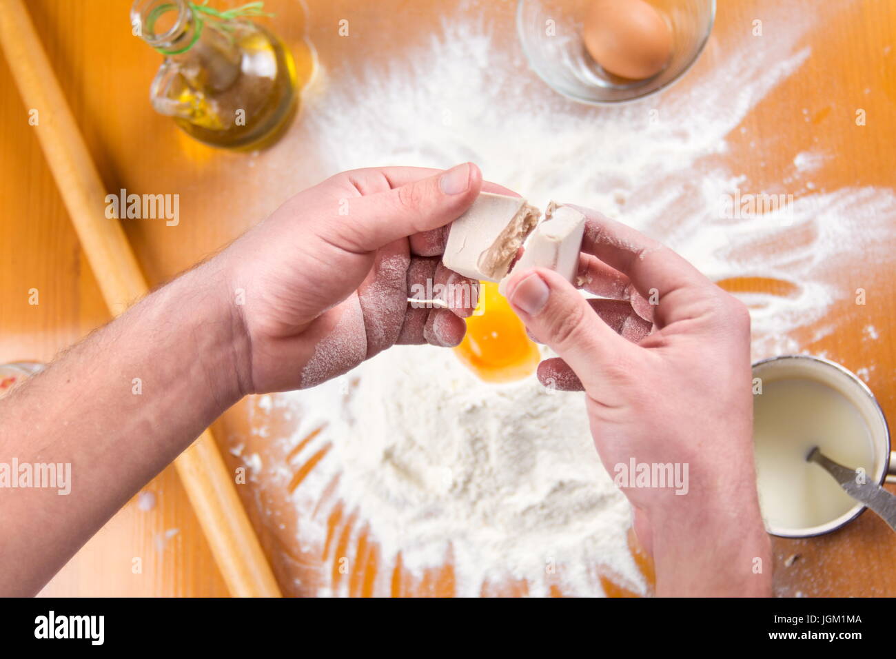 Man spiting yeast in dough making process Stock Photo