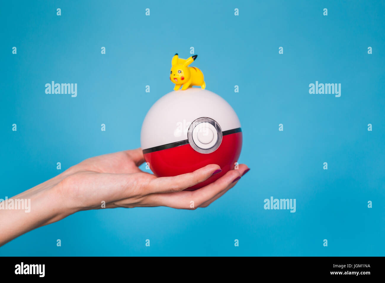 Ufa, Russia July 8, 2017 woman's hand holding pokeball with pikachu