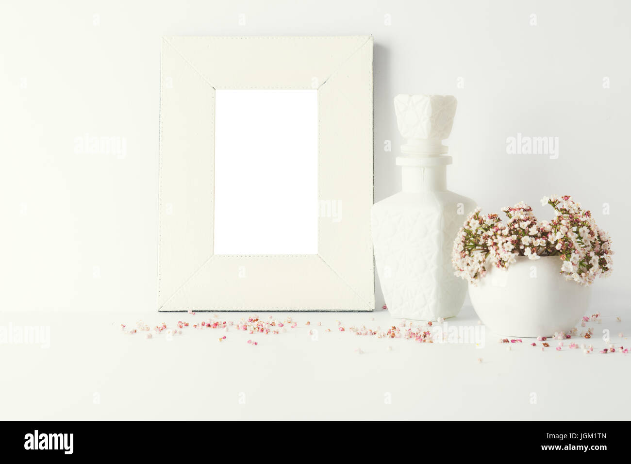 empty picture frame, decorated with small pink flowers and vintage style, white background Stock Photo