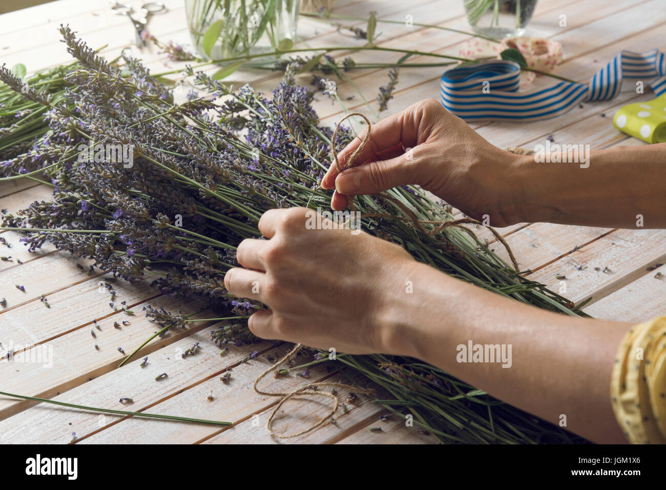 Florist at work: woman creating bouquet of natural lavender flowers ...