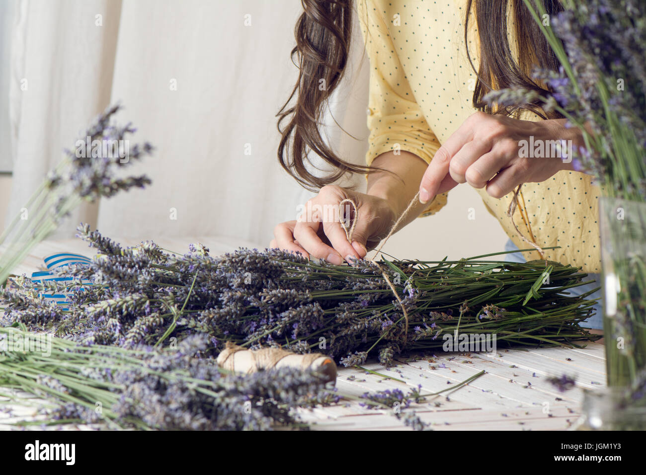 Florist at work: woman creating bouquet of natural lavender flowers ...