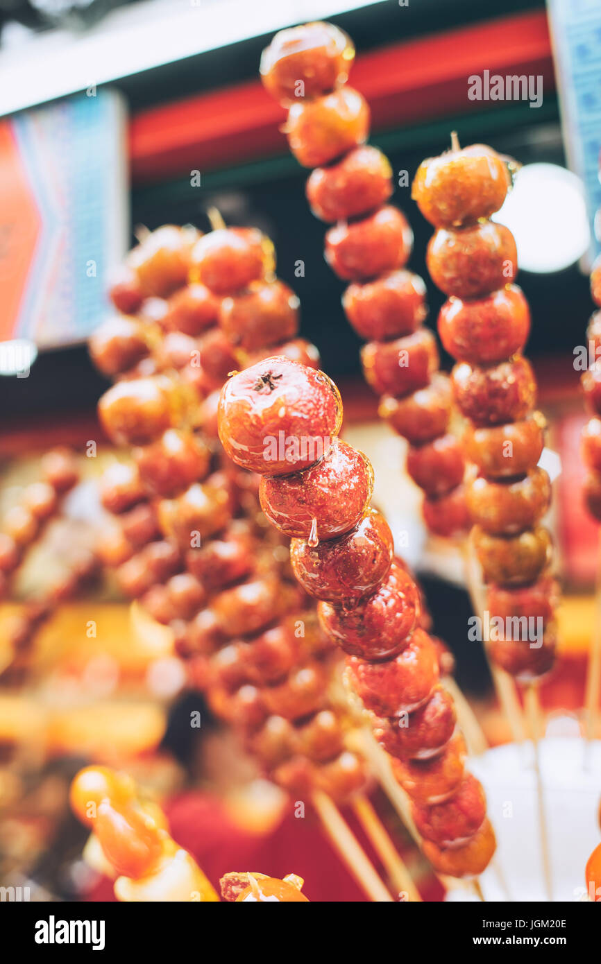 Tanghulu, a traditional snack in Beijing, China. Candied hawthorn fruits on stick Stock Photo