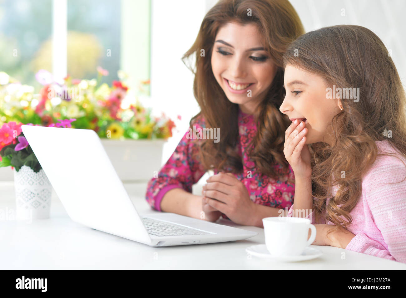 woman and little girl using laptop Stock Photo - Alamy