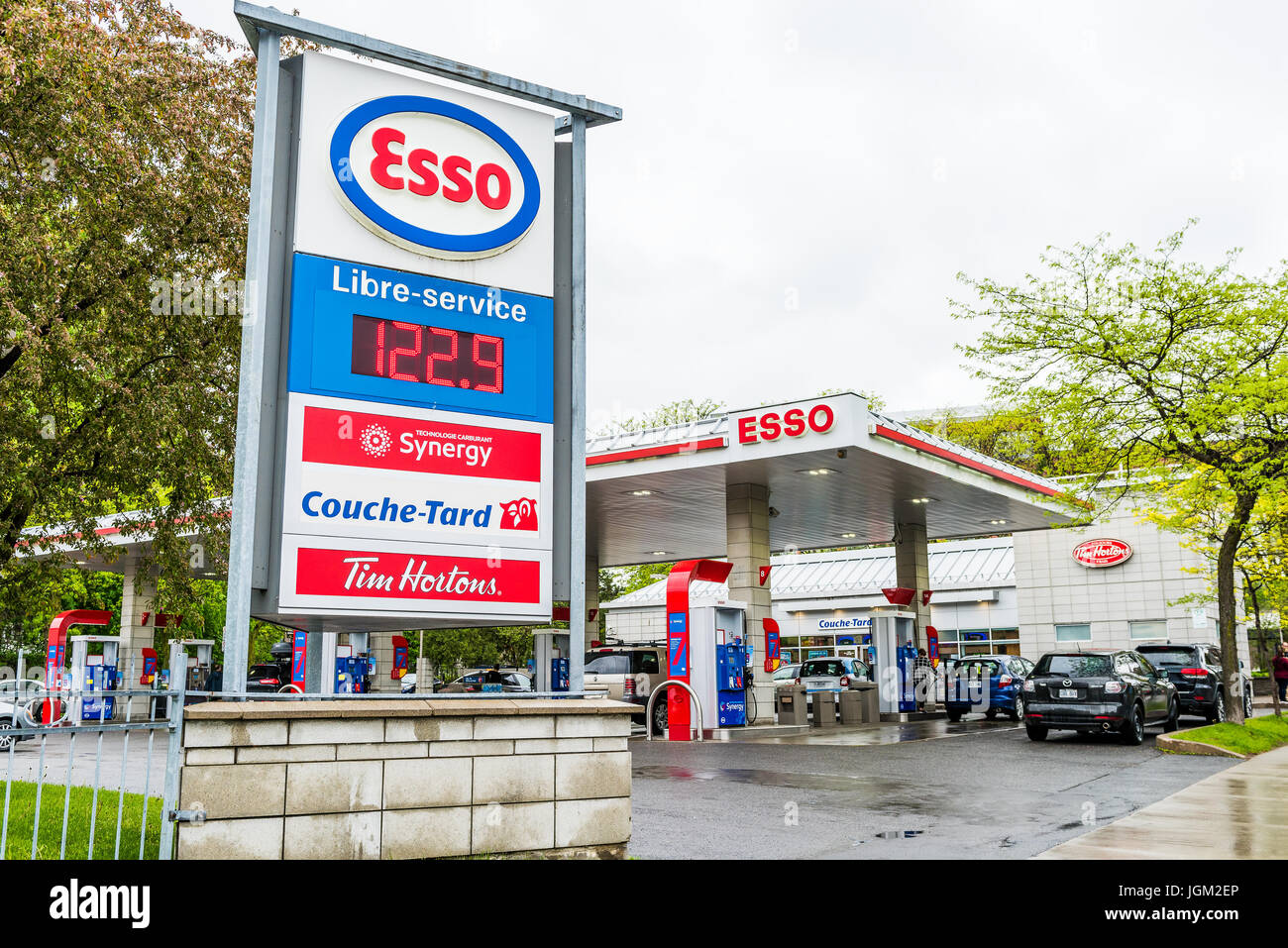 Montreal, Canada - May 26, 2017: Esso gas station in downtown for car fuel with prices and people Stock Photo