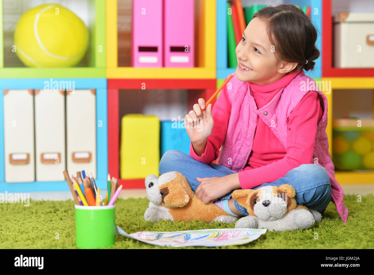 Cute girl sitting on floor Stock Photo - Alamy