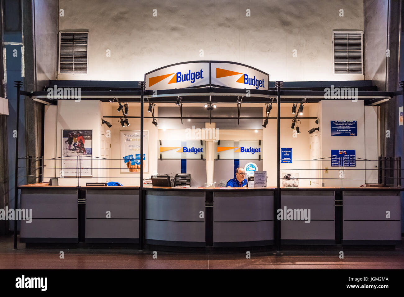 Montreal, Canada - May 26, 2017: Budget rental office in underground city in Quebec region in train station with employee Stock Photo