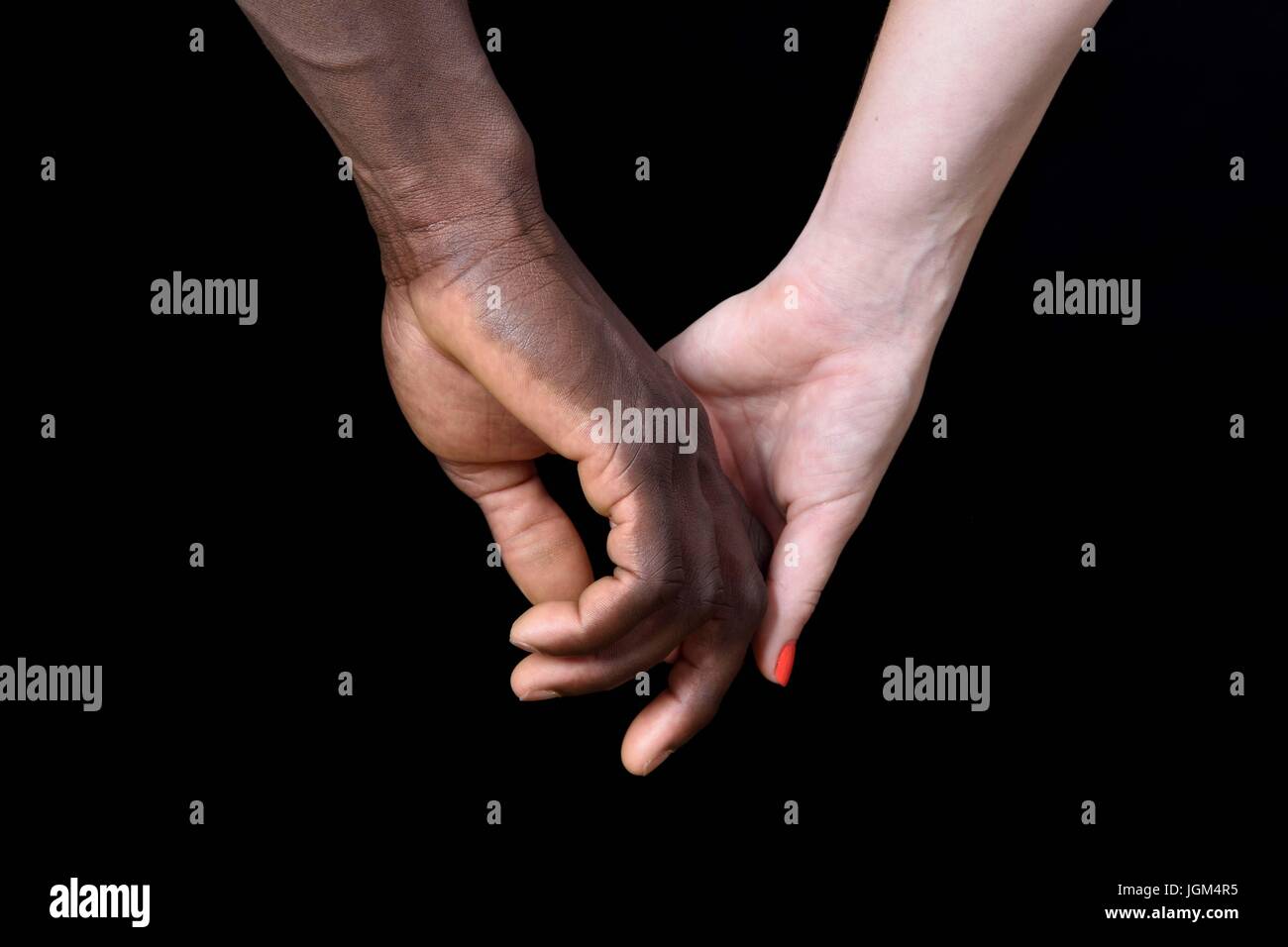 A Hands Of Black Man And White Woman On Black Background Stock
