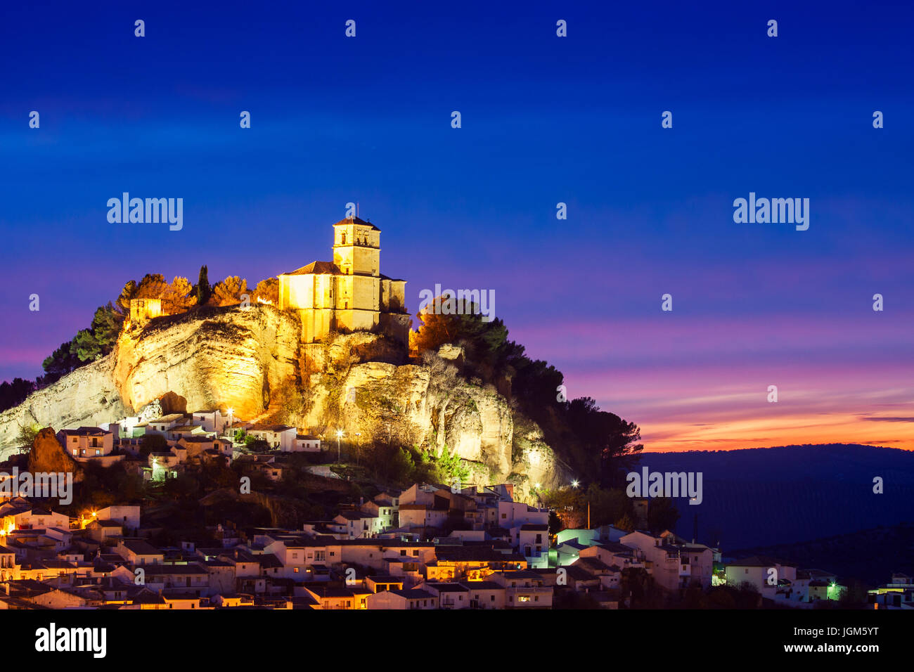 Beautiful sunset in Montefrio and on top of the the rocky outcrop is the Iglesia de la Villa. Granada, Spain Stock Photo