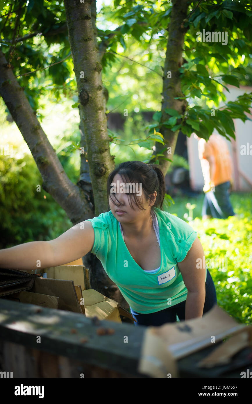 Girl volunteering outside at a community service day Stock Photo