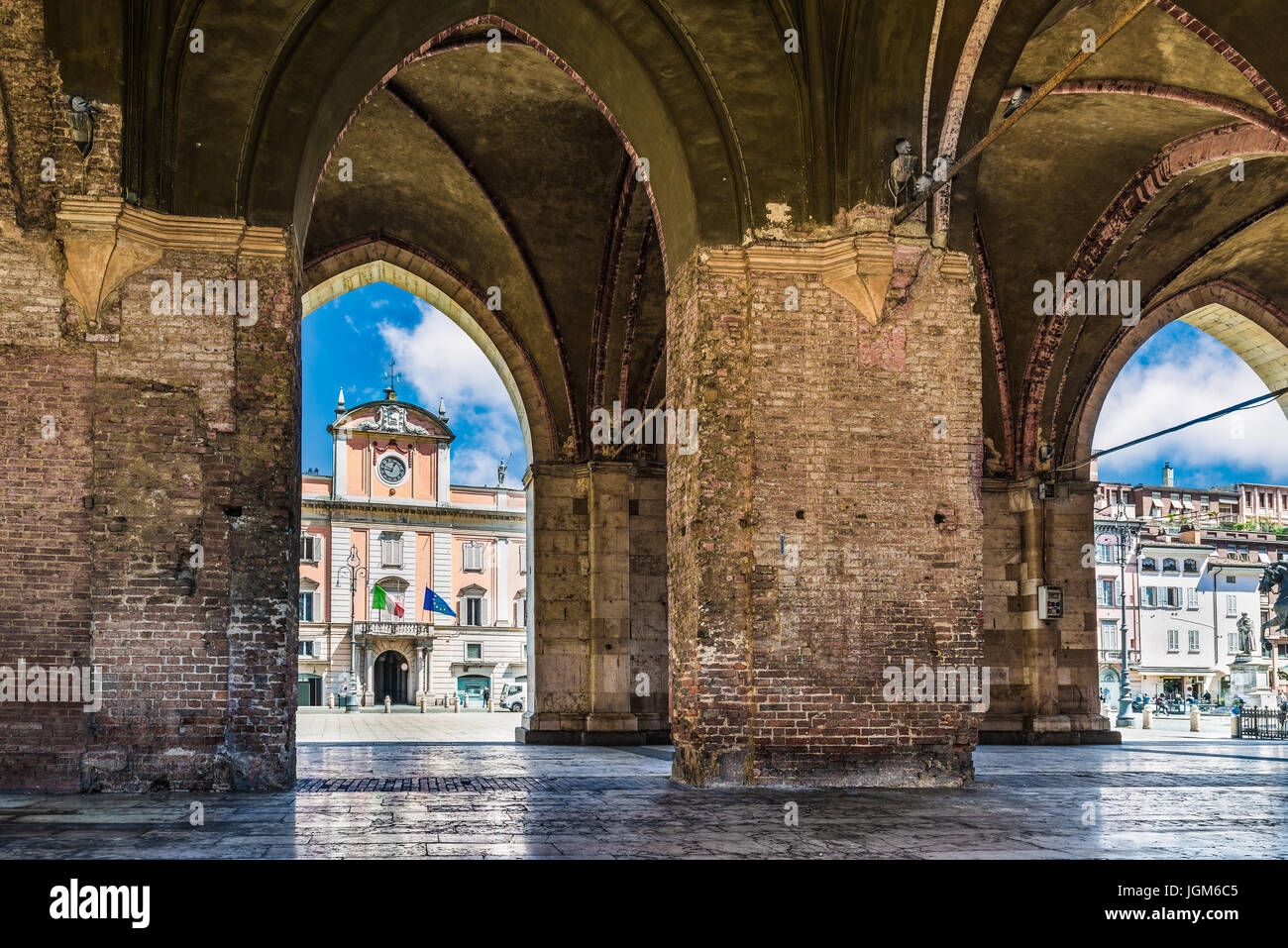 Piacenza, medieval town, Italy. Piazza Cavalli and Palazzo del Governatore from the arcade of palazzo Gotico in the city center Stock Photo