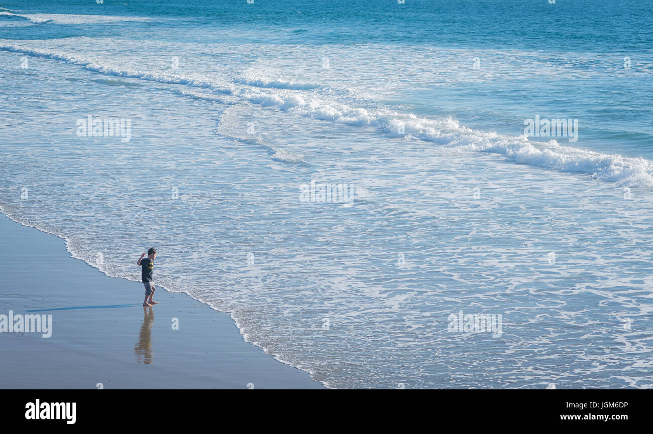 Boy skipping rocks in ocean hi-res stock photography and images - Alamy